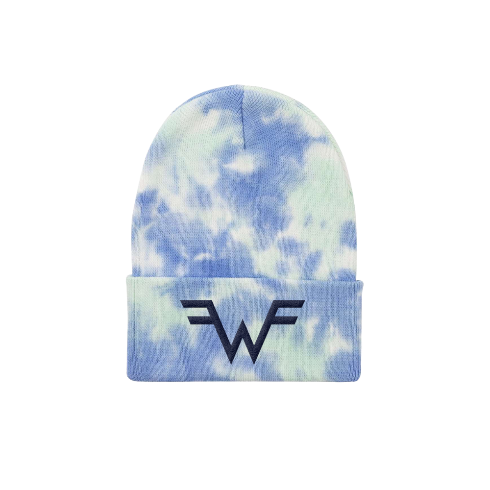A blue and white tie-dye knit beanie featuring a black embroidered ’wf’ logo on the folded cuff.