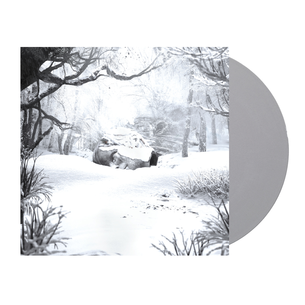 Snow-covered winter forest scene with bare trees and a rock formation.