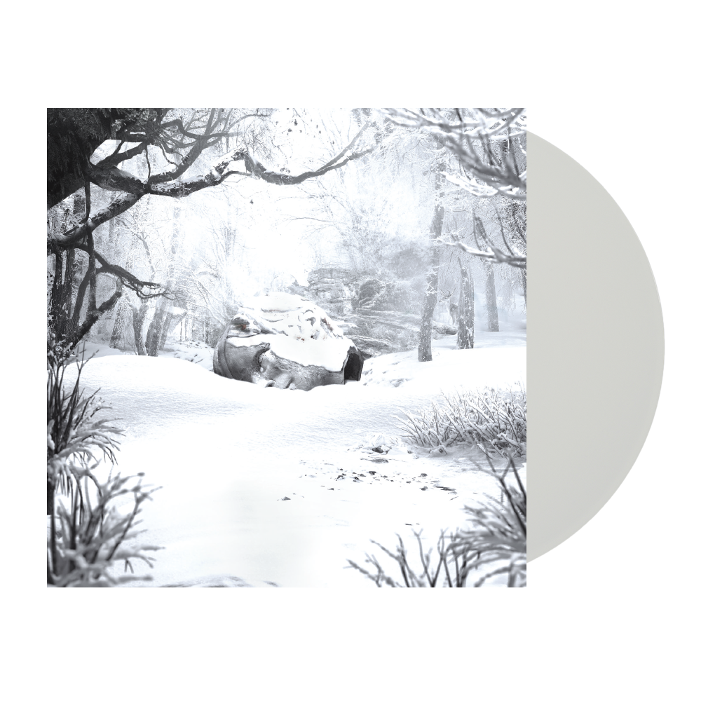 Snow-covered winter forest scene with bare trees and a rock formation.