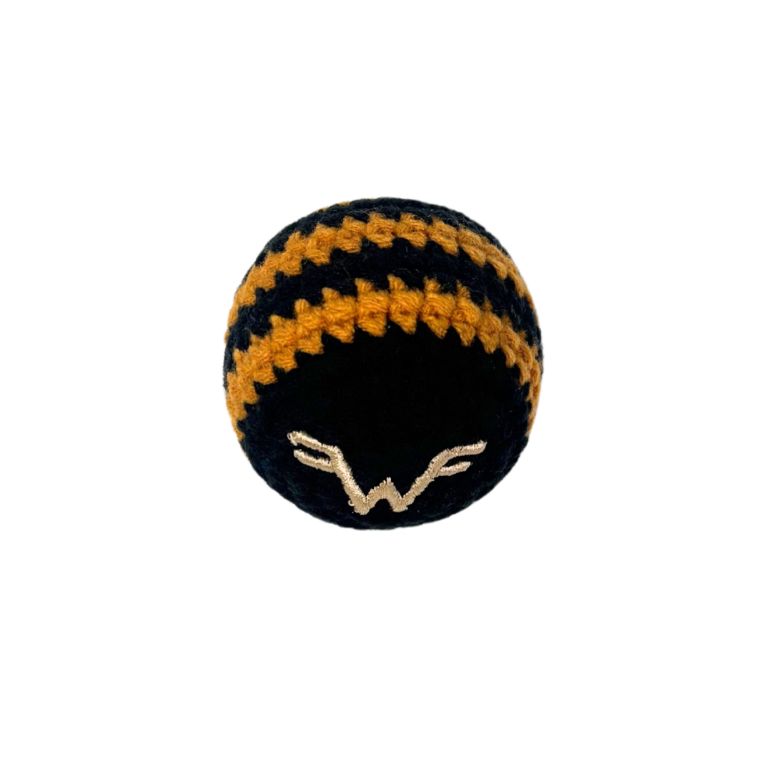 Black and gold striped hacky sack crocheted in black and orange with a white embroidered logo for striped hacky sack play