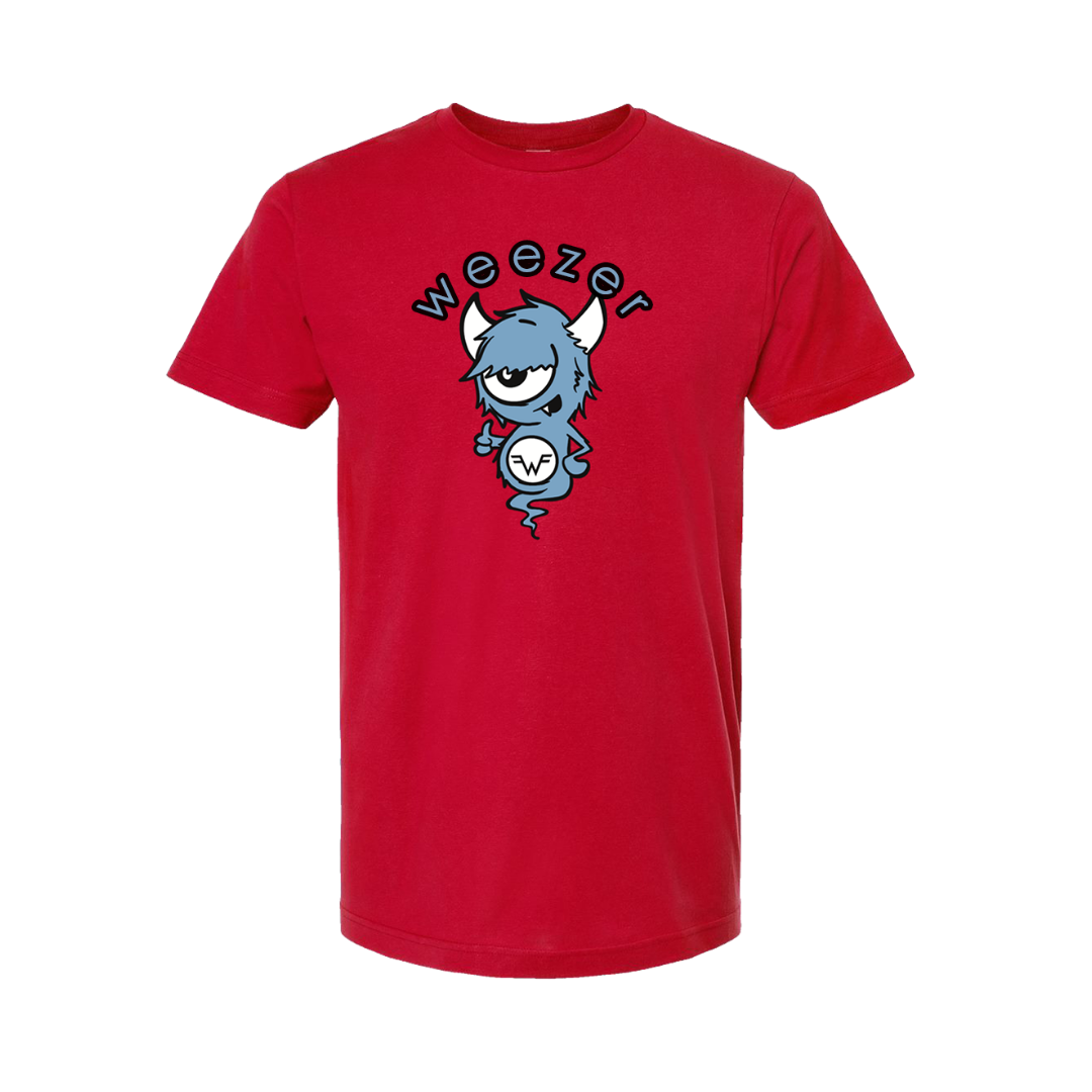 Red short-sleeved t-shirt featuring a cartoon blue monster with horns and one eye, holding a circular ’w’ logo beneath the word “weezer” in black lettering.