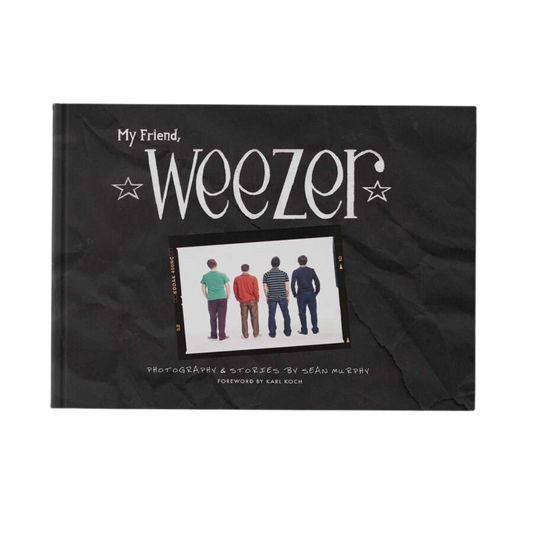 Black hardcover book my friend weezer with white stylized text and photo of rock bands in music photography from weezer official store