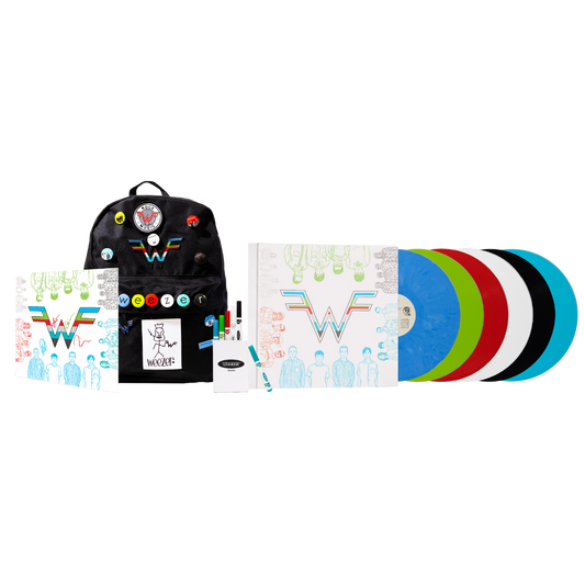 Black backpack with colorful pins and wonder woman patch featuring weezer coloring book deluxe edition design