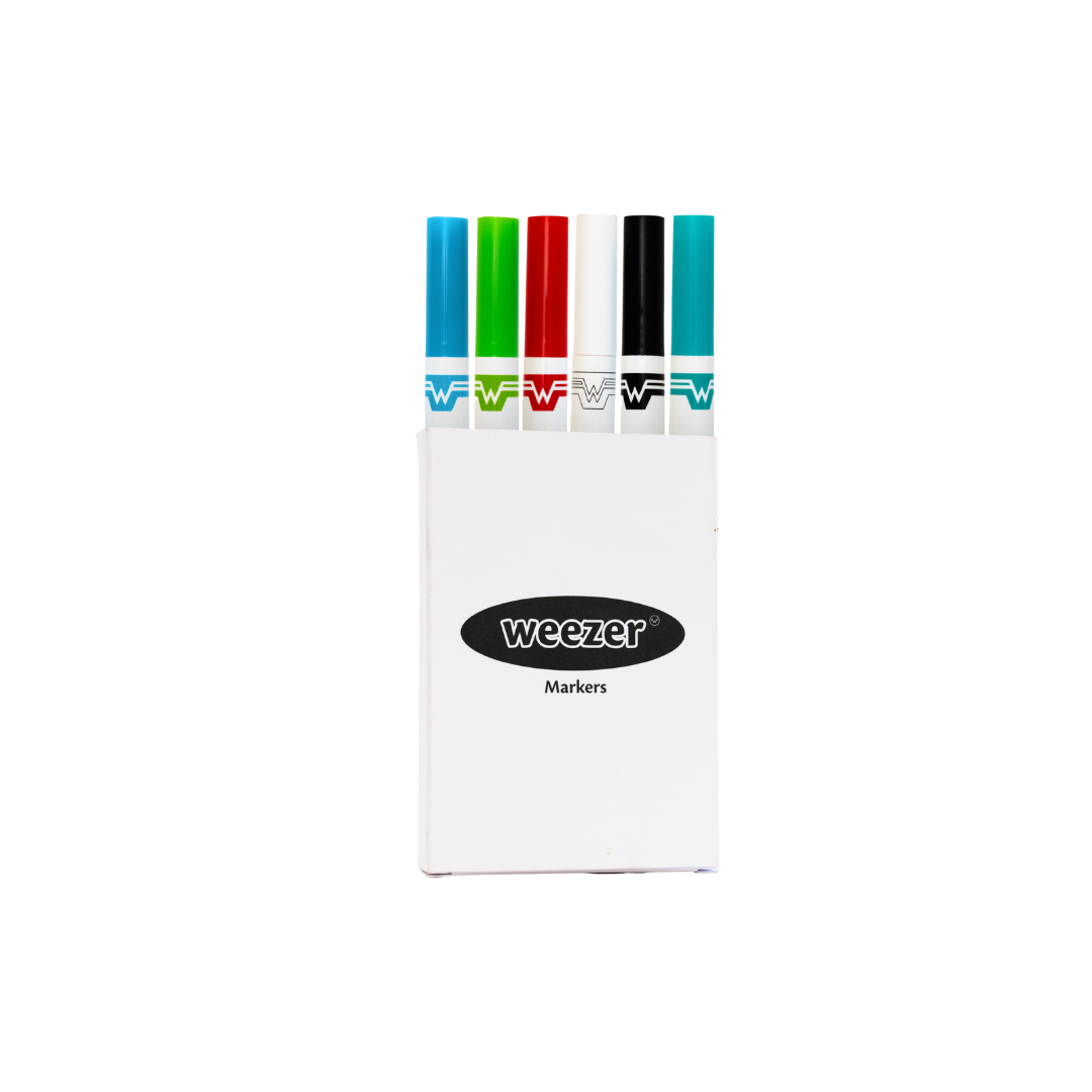 White rectangular case holding six colorful weezer brand markers with blue, green, red, white, black, and teal caps.