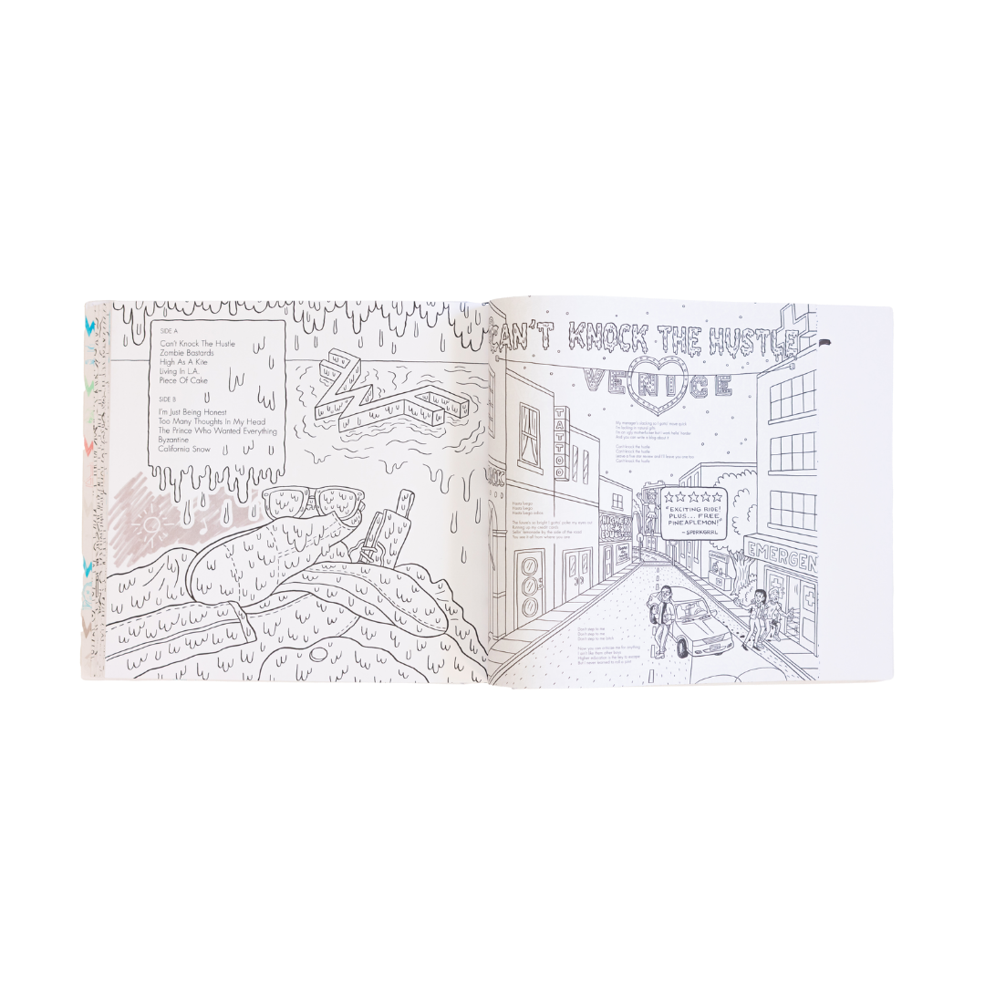 Open coloring book featuring black-and-white line art of a street scene with buildings, cars, and people.